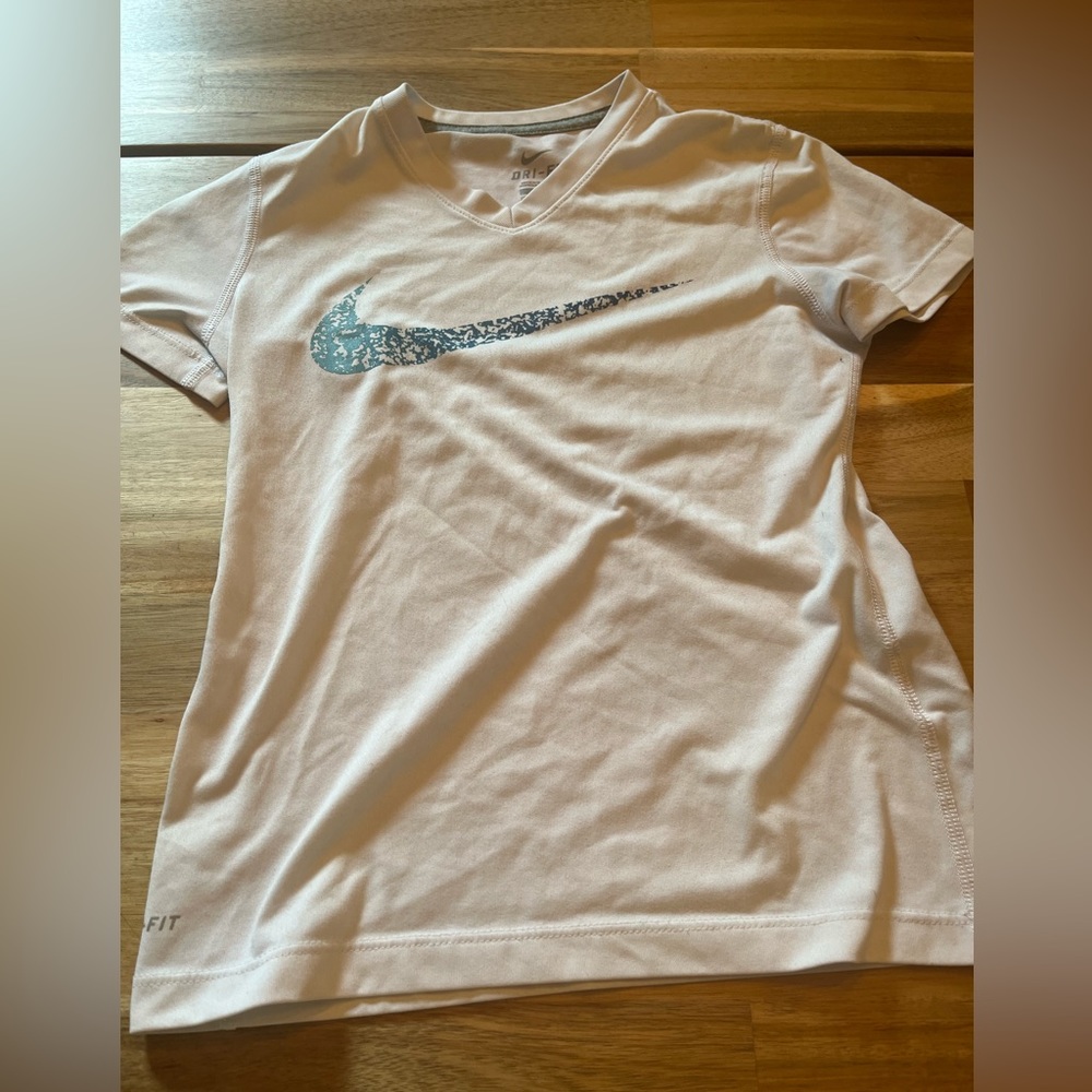 children white nike shirt with blue nike swoosh